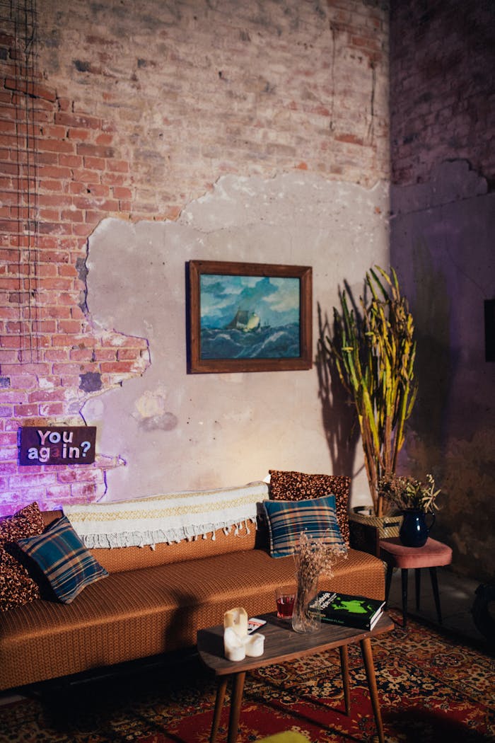 A cozy retro living room with vintage decor, featuring a sofa, painting, and unique wall textures.